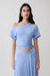 Woman wearing a blue off shoulder slinky top