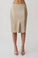 Woman wearing a gold satin midi skirt.