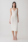 Woman wearing a white scalloped neckline pointelle midi dress.