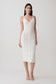 Woman wearing a white scalloped neckline pointelle midi dress.