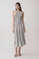 Woman wearing a striped blue and brown halter neck knit midi dress.