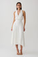Woman wearing a white hankie halter midi dress.