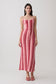 Woman wearing a pink and red striped crochet halter maxi dress.