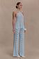 Woman wearing a light blue crochet halter top.