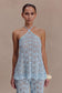 Woman wearing a light blue crochet halter top.