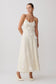 Woman wearing a white floral maxi dress.