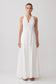 Woman wearing a white sleeveless maxi dress.