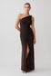 Woman wearing a brown one-shoulder maxi dress with a slit.