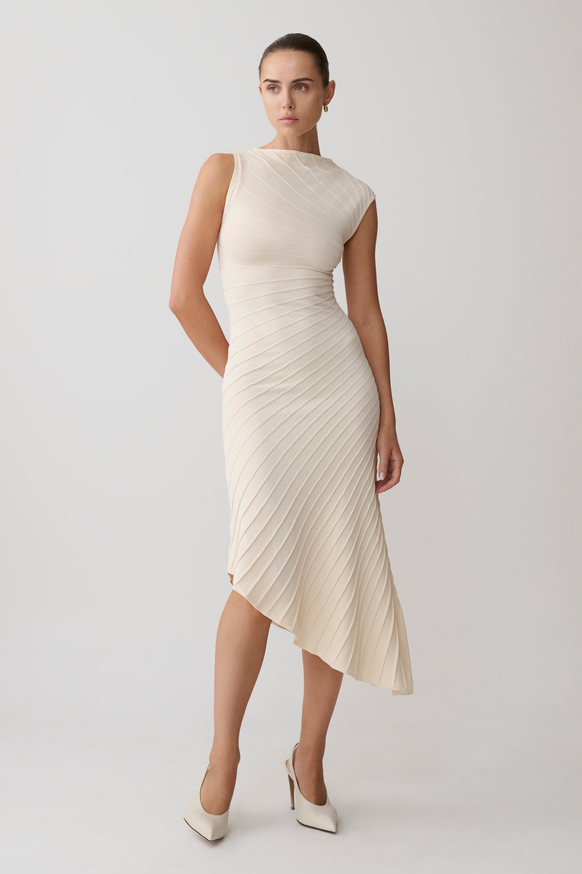 Woman wearing a white pleated maxi dress.