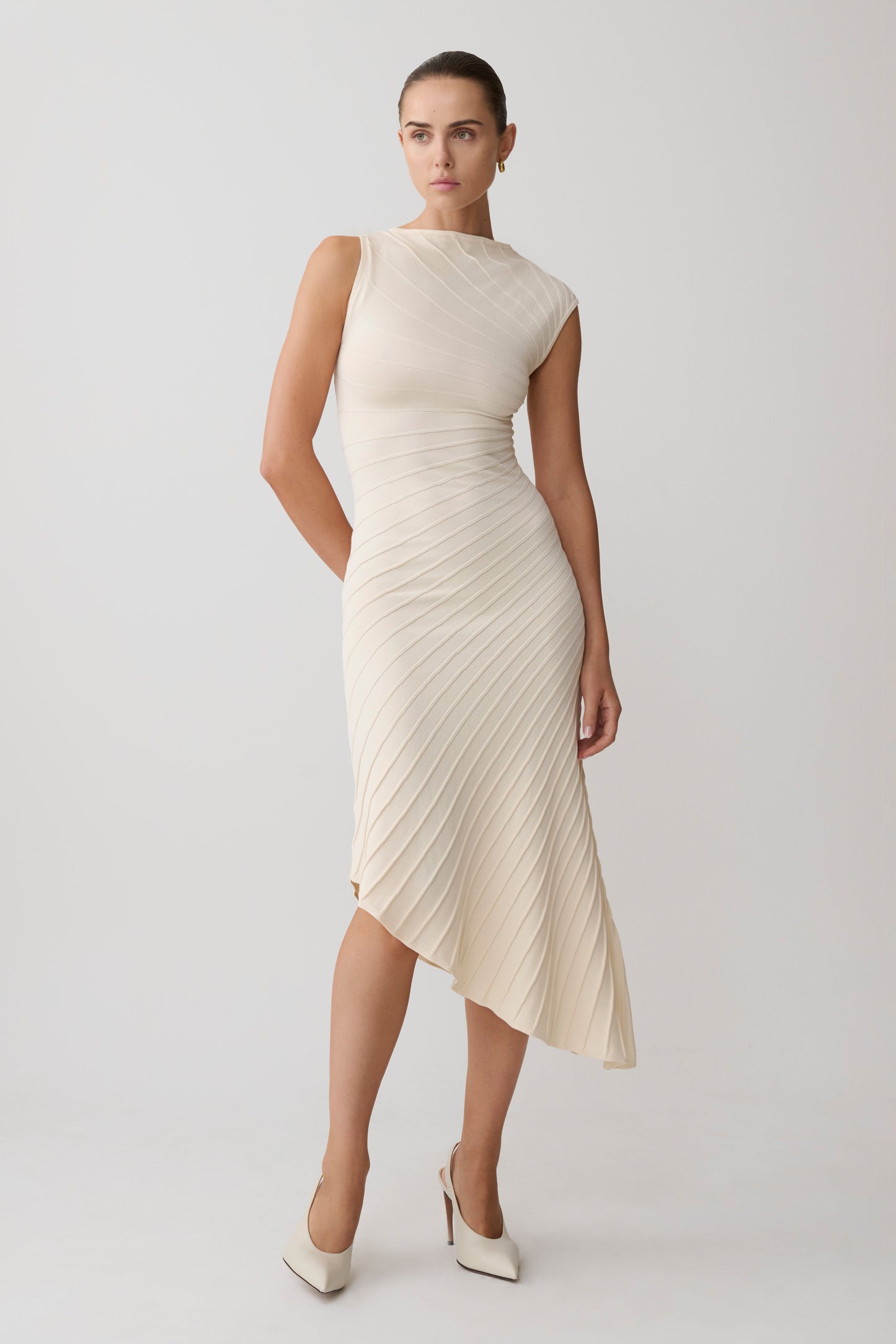 Woman wearing a white pleated maxi dress.
