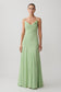 Woman wearing a light green chiffon maxi dress.