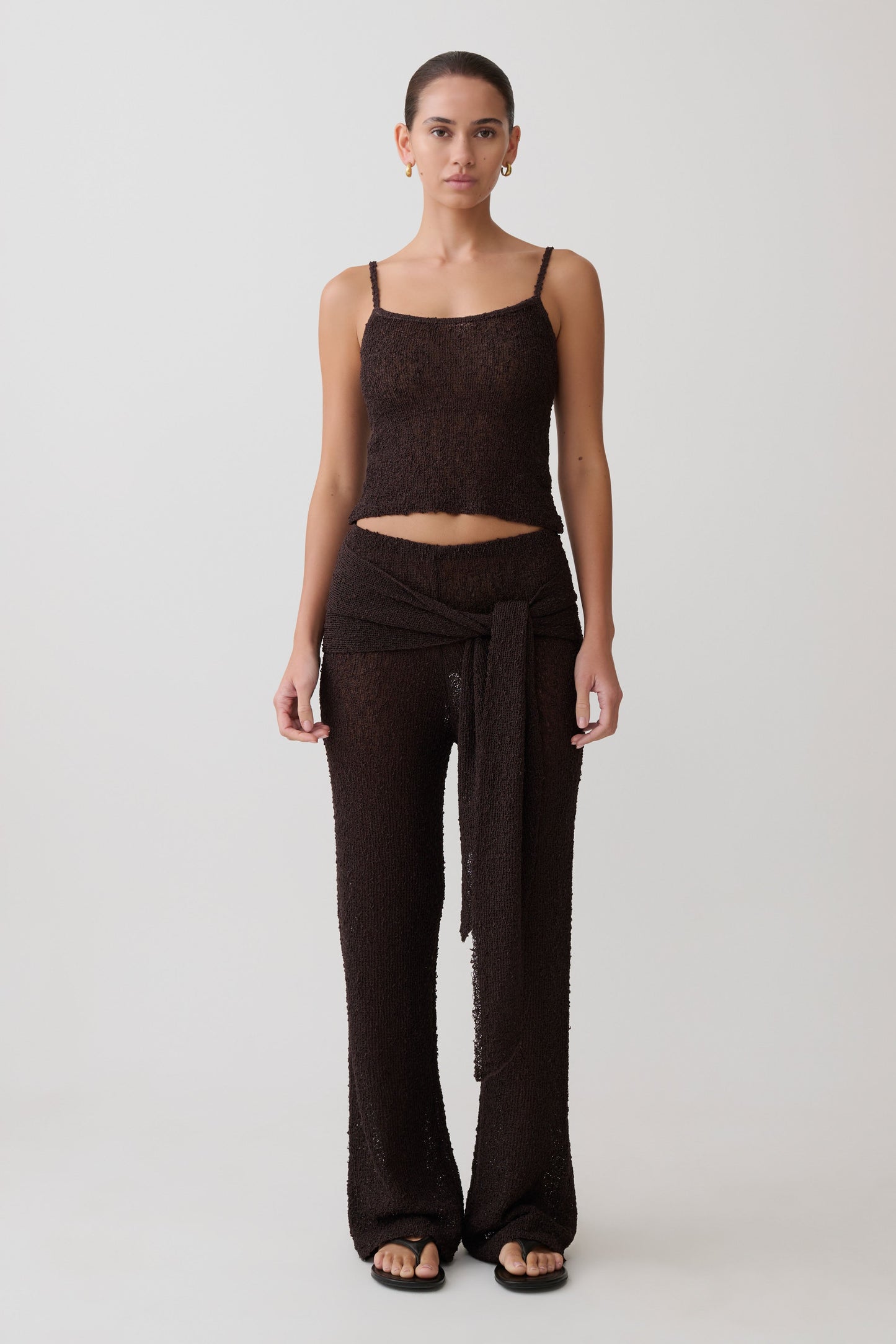 Woman wearing a brown boucle sleeveless top and matching wide-leg pants.