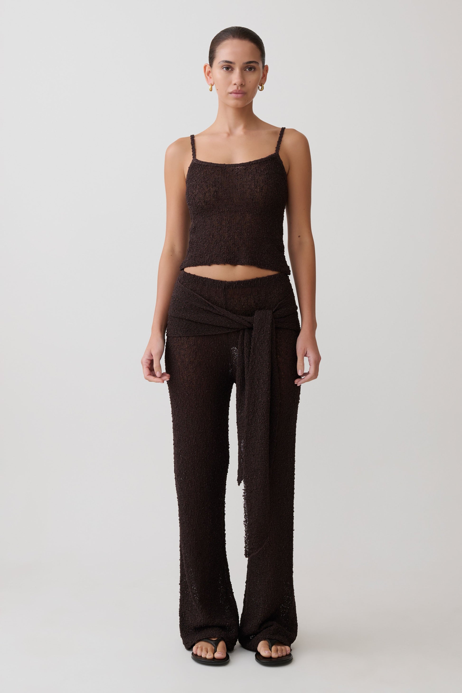 Woman wearing a brown boucle sleeveless top and matching wide-leg pants.