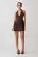 Woman wearing a brown halter neck mini dress.