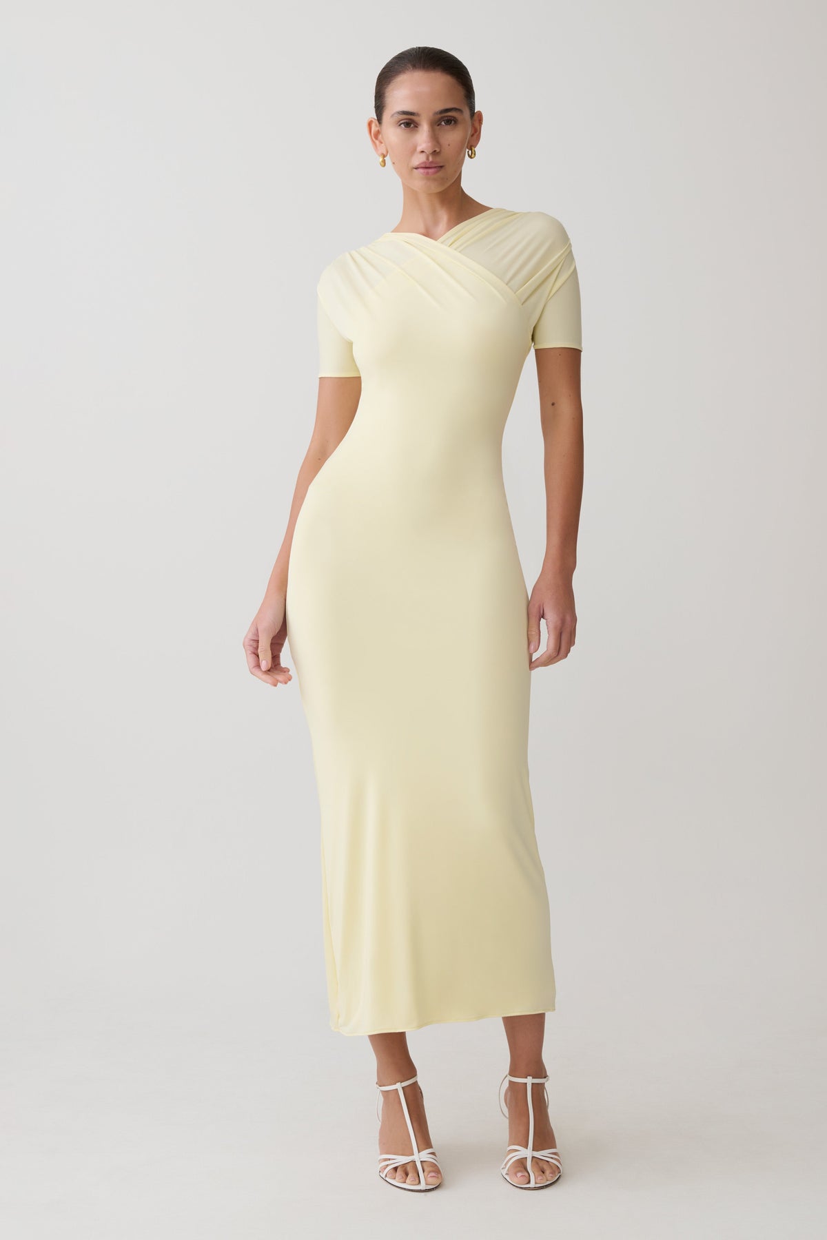 Woman wearing a light yellow maxi dress.