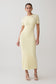 Woman wearing a light yellow maxi dress.