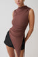 Woman wearing a brown sleeveless top.