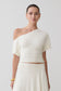 Woman wearing a white off-shoulder top.