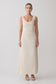 Woman wearing a cream-coloured striped maxi dress.