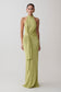 Woman wearing a green halter neck dress.