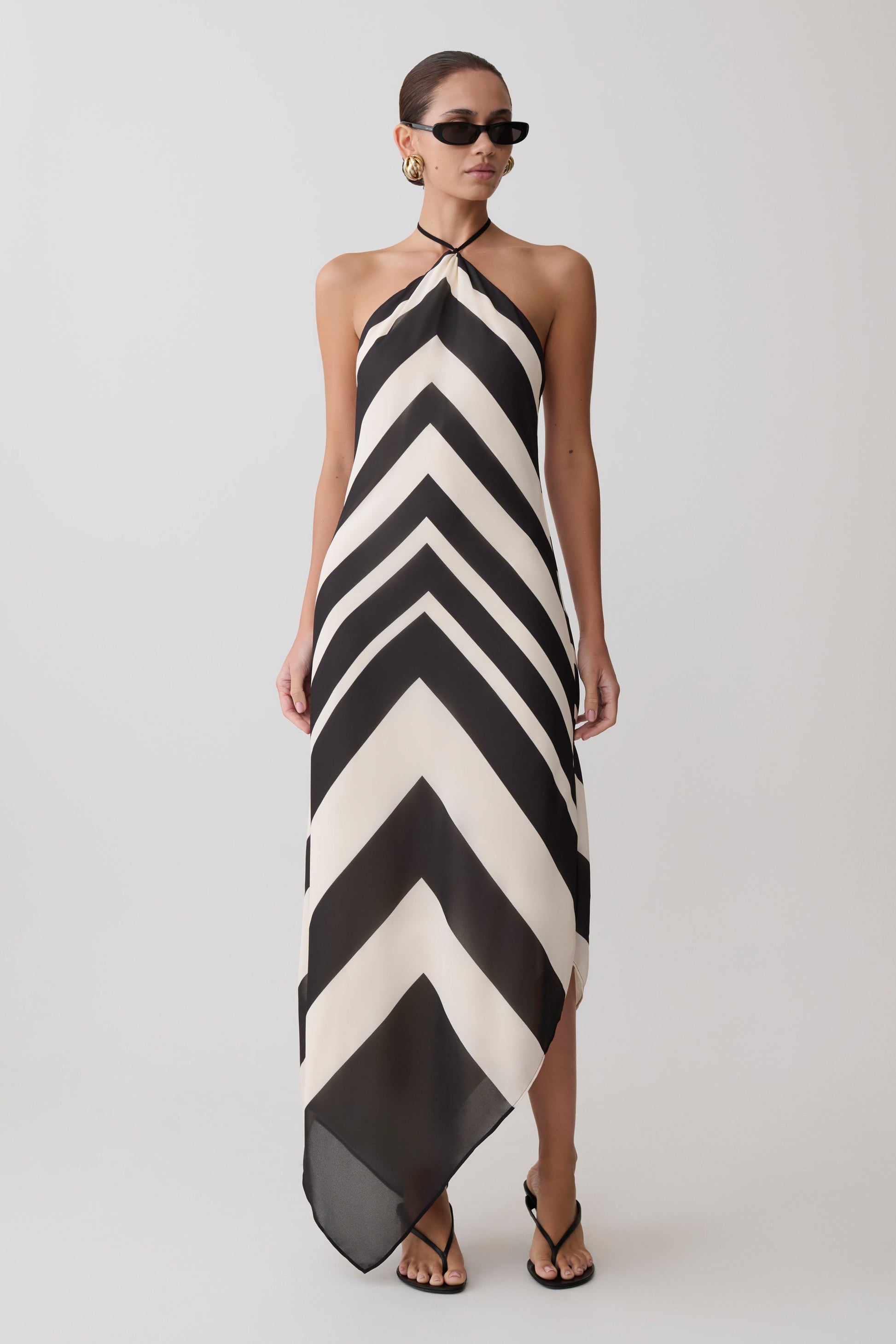 Woman wearing a black and white chevron patterned dress.