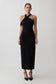 Woman wearing black crossover neck dress.