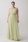 Woman wearing a light green strapless gown against a plain background