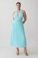 Woman wearing a light blue halter neck maxi dress.