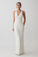 Woman wearing a white plunge neck maxi gown.