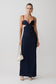 Woman wearing a navy blue dress with cut-out design on a white background