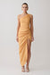 Woman wearing a yellow one-shoulder dress on a white background