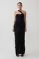 Woman wearing a black one-shoulder dress on a white background
