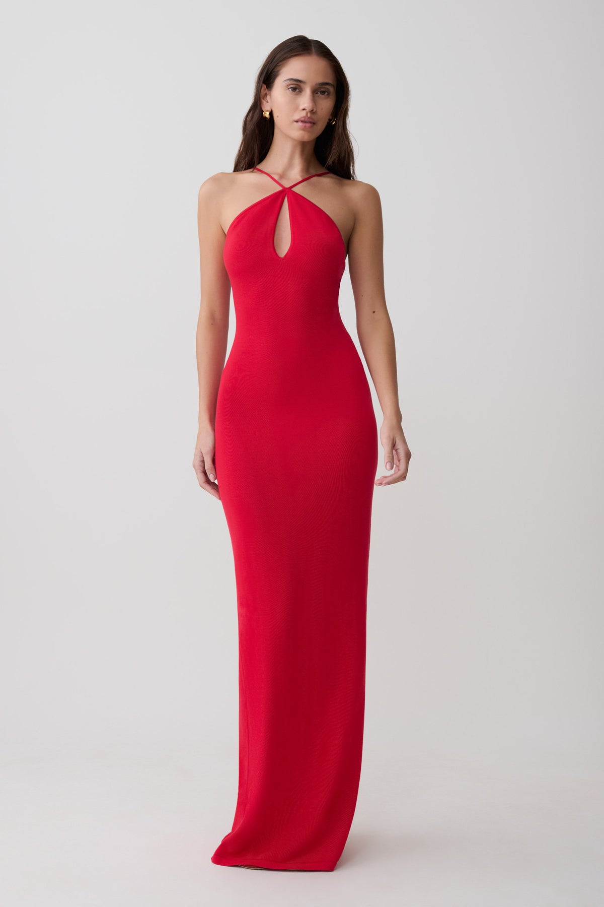 Woman wearing a red cross front knit maxi dress.