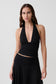 Woman wearing a black modal gathered halter top.