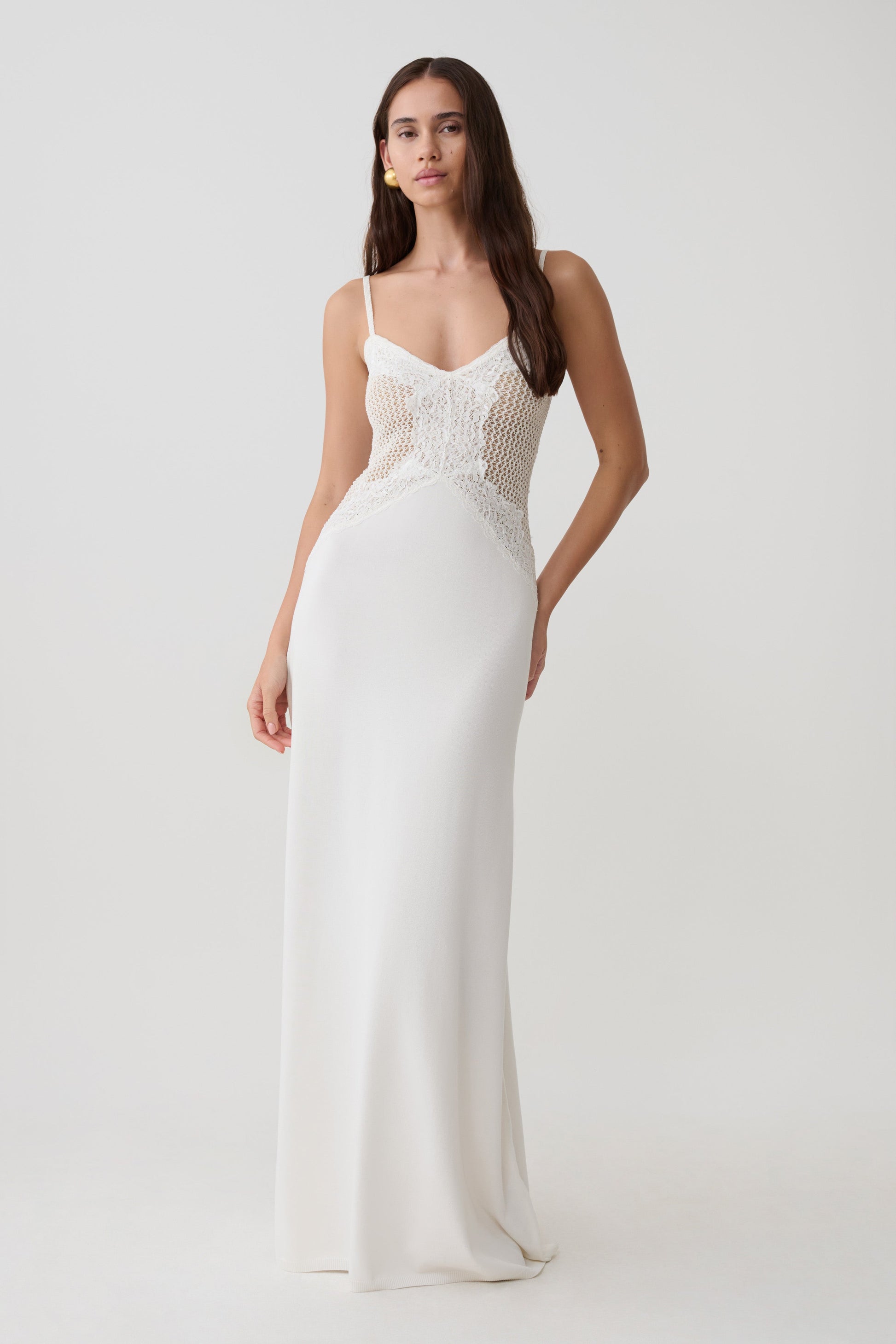 Woman wearing a knit and lace maxi dress.