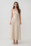 Woman wearing a frayed linen tube top with matching skirt set.