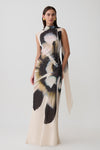 Woman wearing a chiffon maxi dress with ivory print.