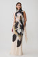 Woman wearing a chiffon maxi dress with ivory print.