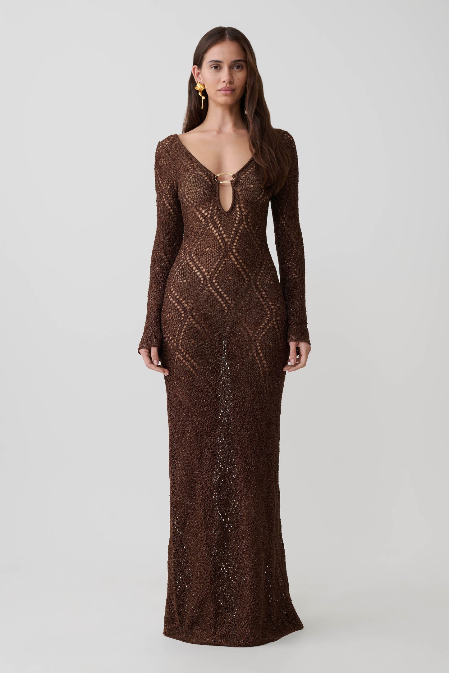 Woman wearing a brown lurex crochet long-sleeve dress.