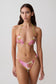 Woman wearing a pink flower print triangle bikini set.