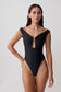 Woman wearing a black one-piece off-shoulder swimsuit.