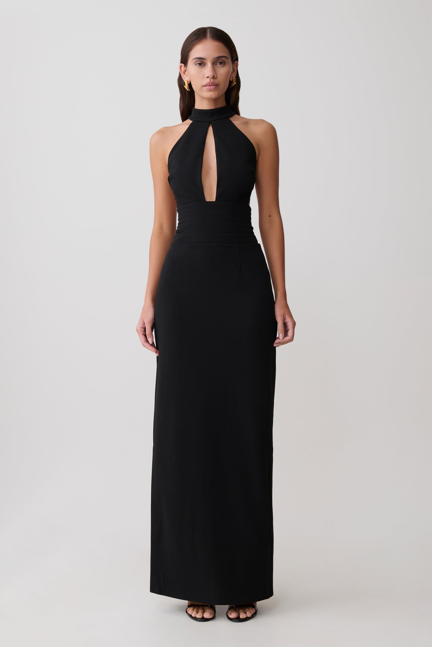 Woman wearing black stretch crepe maxi dress.