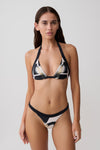 Woman wearing a black and white floral print bikini set.