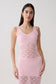 Woman wearing a pink sleeveless crochet top.