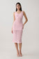 Woman wearing a pink sleevesless crochet top with matching skirt.