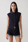 Woman wearing dark blue collared denim longline top with matching denim shorts.
