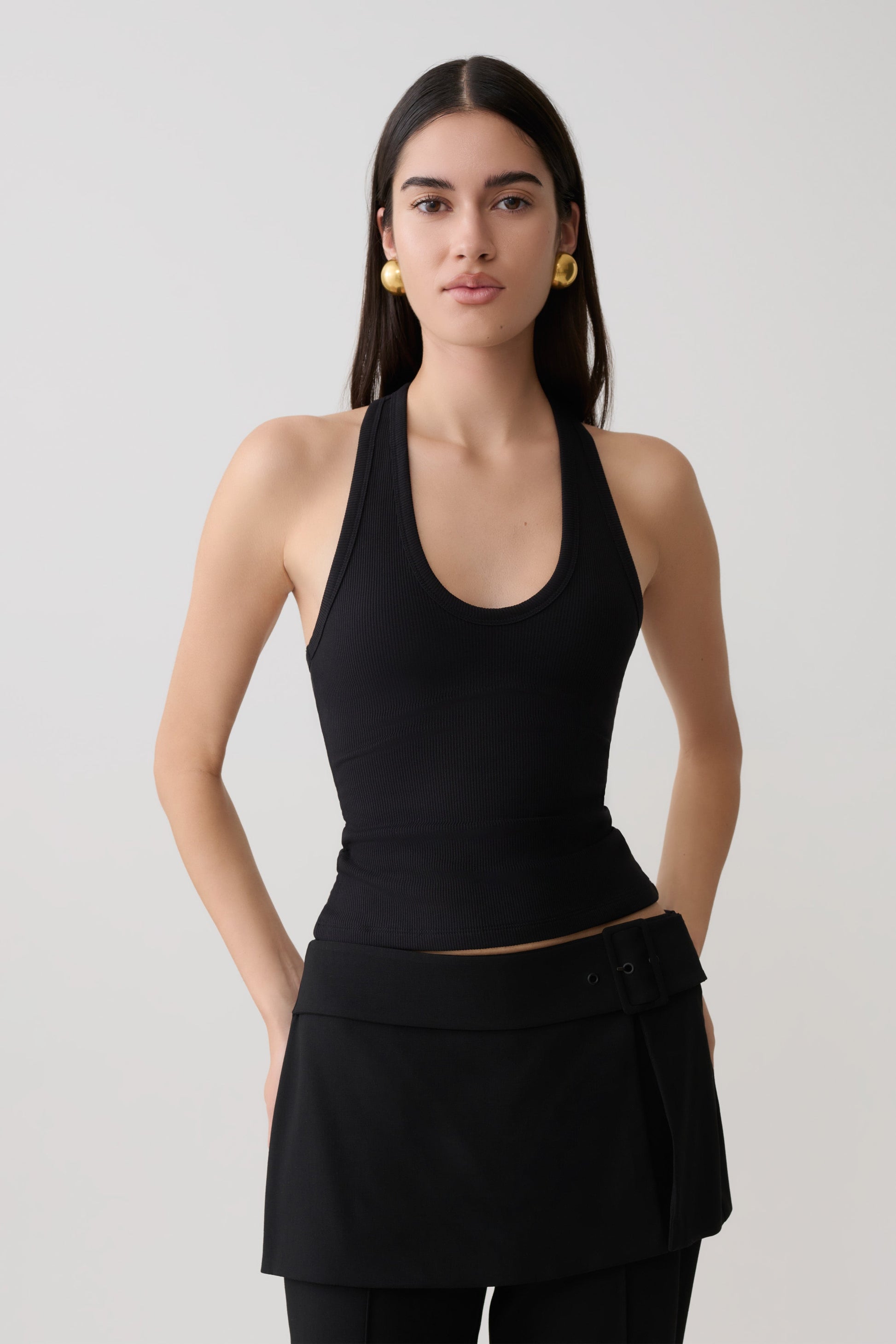 Woman wearing a black ribbed tank.