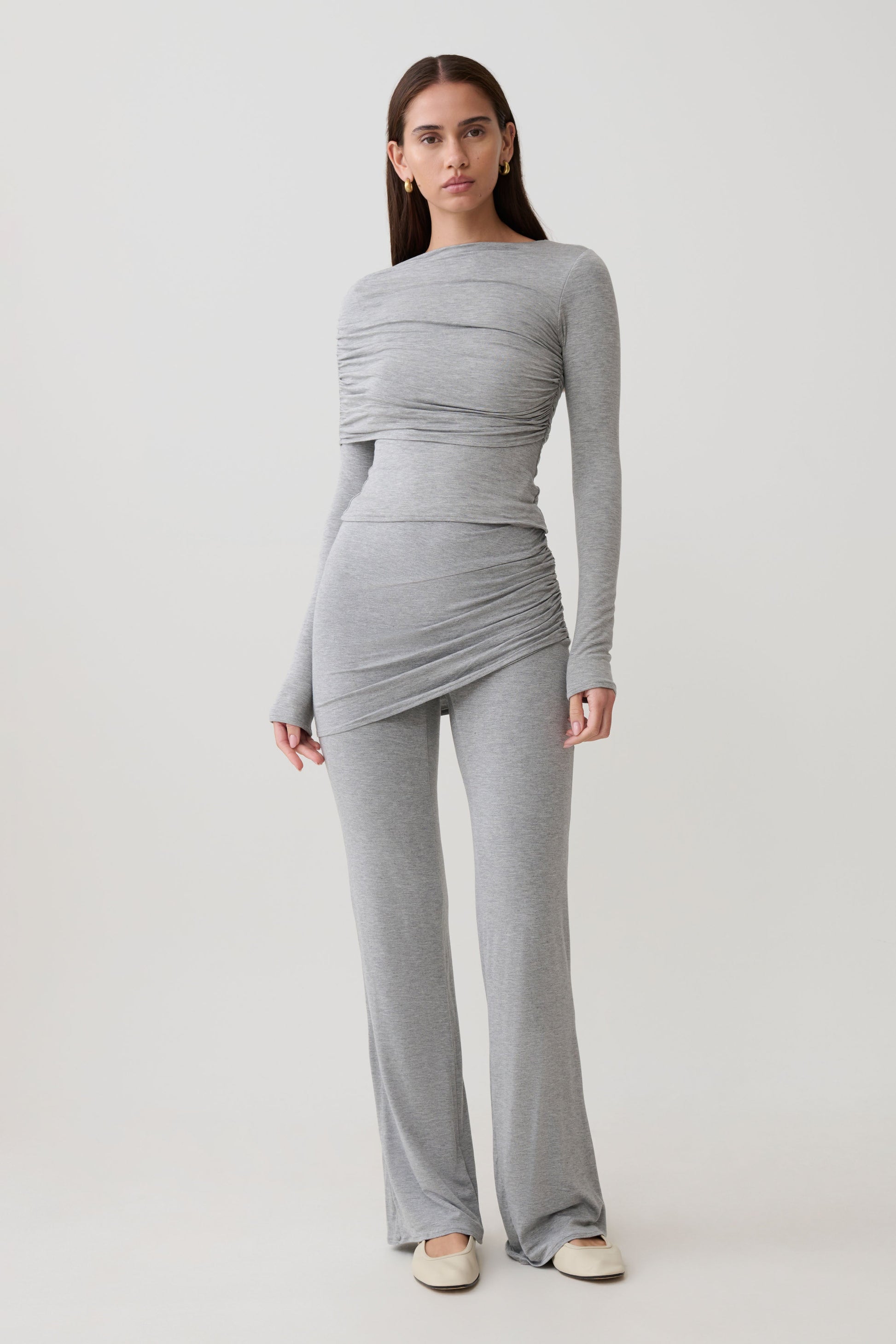 Woman wearing a grey modal straight leg overlay pant with matching top.