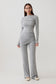 Woman wearing a grey modal straight leg overlay pant with matching top.