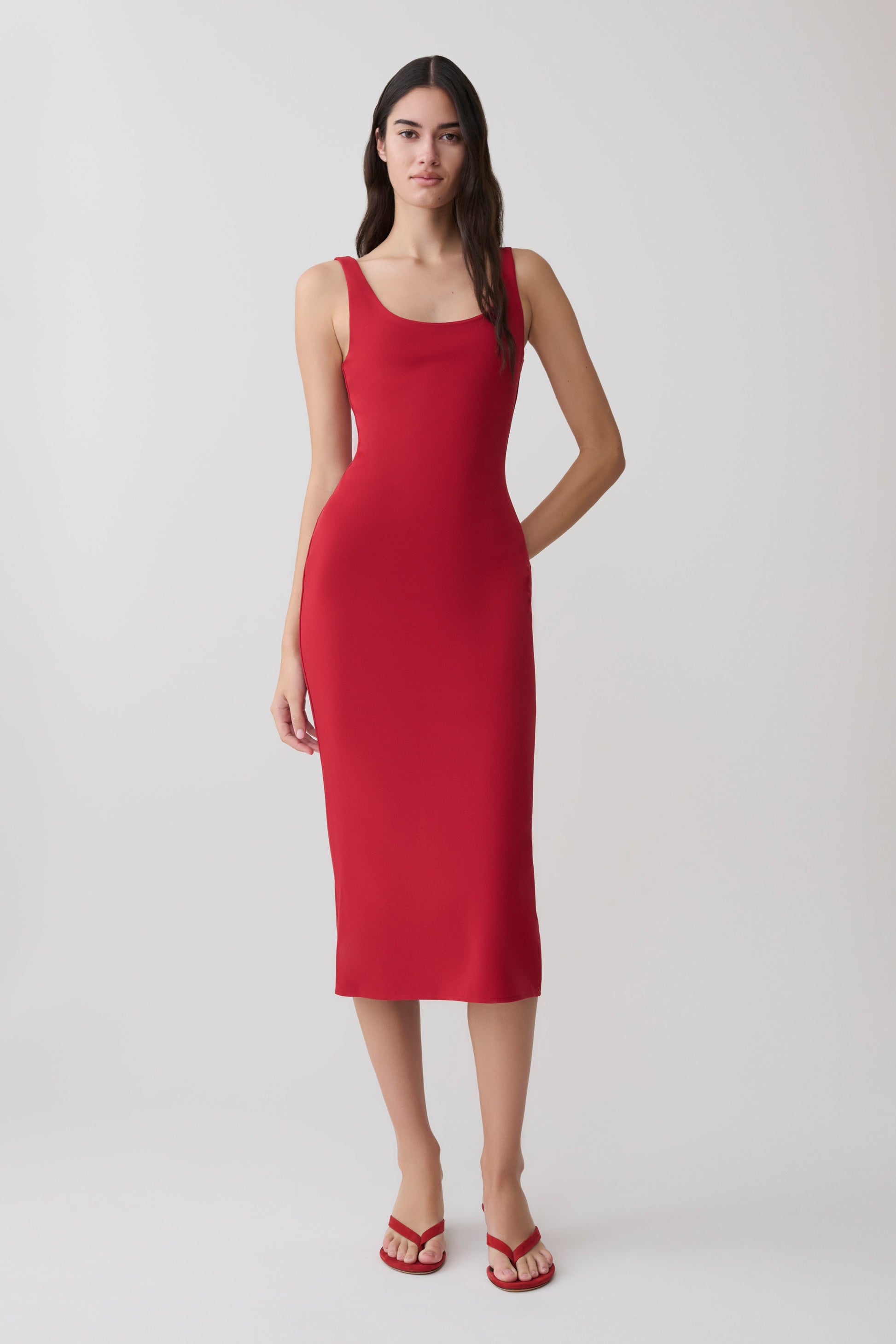 Woman wearing a red crepe midi dress.